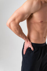 Athletic man touching his painful hip